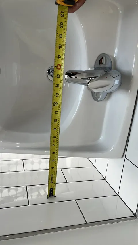 Close-up of commercial sink faucet and drain height check, Orlando FL