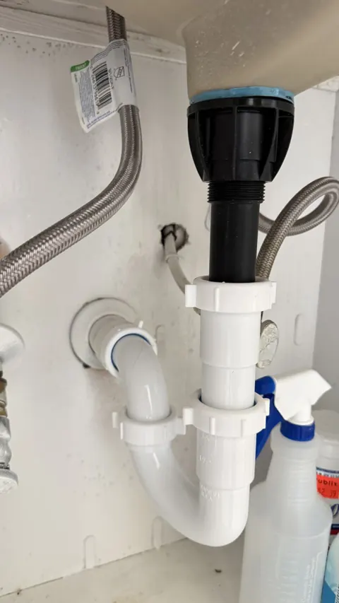 Testing new sink drain for leaks with running water, Orlando FL